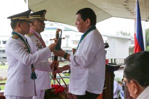 President Rodrigo Roa Duterte hands over the saber to newly-appointed Armed Forces of the Philippines (AFP) Chief of Staff Lieutenant General Eduardo Año during the Change of Command Ceremony at the AFP General Headquarters Grandstand in Camp General Emilio Aguinaldo, Quezon City on December 7, 2016. Also in the Photo is outgoing AFP Chief of Staff Lieutenant General Ricardo Visaya. ALBERT ALCAIN/Presidential Photo