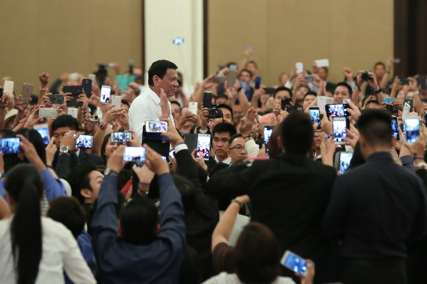 President Rodrigo Roa Duterte stands before a crowd of supporters as he visited the Filipino community in Cambodia at the Sofitel Phnom Penh Phokeethra Hotel on December 13, 2016. KING RODRIGUEZ/Presidential Photo