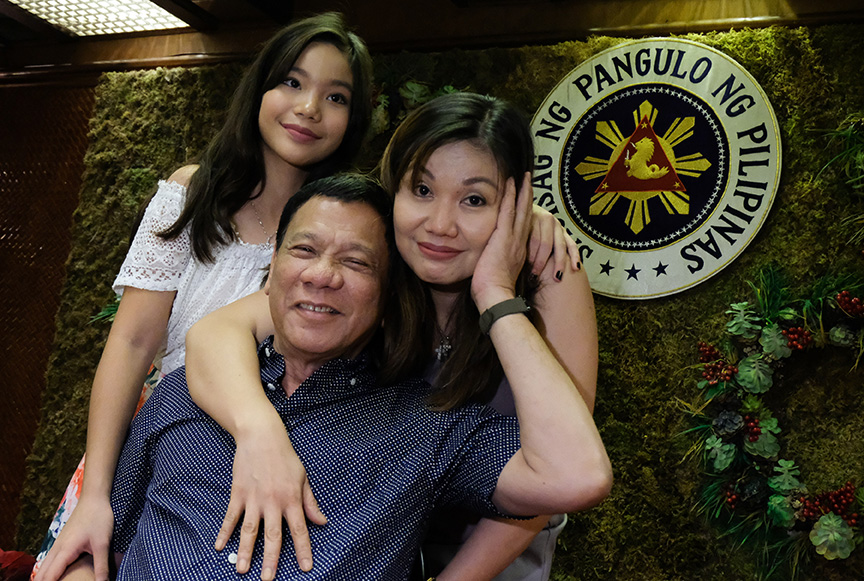 President Rodrigo Roa Duterte, his common-law wife Honeylet Avanceña, and their daughter Veronica pose for a photo during the Christmas party in Malacañang on December 20, 2016. KING RODRIGUEZ/Presidential Photo