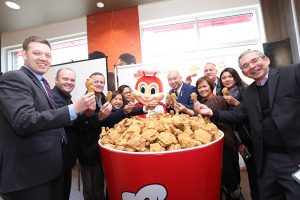 Jollibee executives and special guests gather around a giant bucket of fried chicken for the Jolly Crispy Chicken toast. Seen here are JFC Group President for North America and Foreign Franchise Brands Jose Miñana, VP and General Manager of Jollibee North America Maribeth dela Cruz, Honorary Consul Ronald Opina, Member of the Legislative Assembly for St. Norbert Jon Reyes, President of Sysco Winnipeg Blair Schmidt, Trevor Skinner, and other special guests. (Photo courtesy of Jollibee)