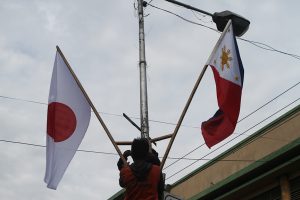 DPWH personnel on Tuesday install flags on of Philippines and Japan along JP Laurel Avenue, Davao City ahead of the visit of Japan Prime Minister Shinzo Abe on Friday in the city. CONTRIBUTED PHOTO