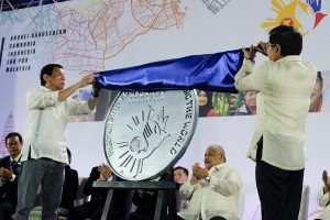 President Rodrigo Roa Duterte and Bangko Sentral ng Pilipinas (BSP) Governor Amando Tetangco Jr. unveil the commemorative coin for the Philippines' Association of Southeast Asian Nations (ASEAN) chairmanship for 2017 during a ceremony at the SMX Convention Center in Davao City on January 15, 2017. RENE LUMAWAG/Presidential Photo
