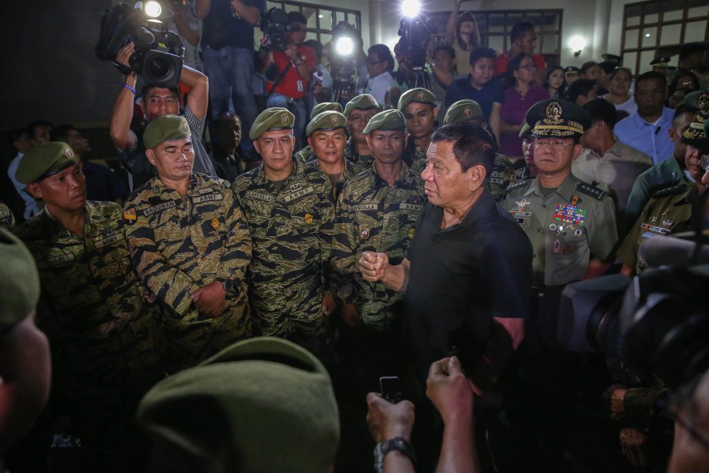 President Rodrigo Duterte speaks to the surviving platoon mates of the late Captain Clinton Capio during his wake visit at the mortuary of the Libingan ng mga Bayani in Fort Bonifacio on January 16, 2017. Capio, a Philippine Military Academy Class 2006, was killed in a clash with the Abu Sayaff members last Thursday. ALBERT ALCAIN/Presidential Photos