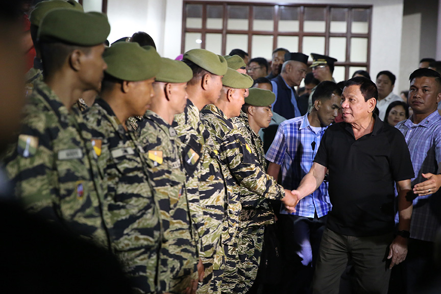 President Rodrigo Duterte salutes to the surviving platoon mates of the late Captain Clinton Capio during his wake visit at the mortuary of the Libingan ng mga Bayani in Fort Bonifacio on January 16, 2017. Capio, a Philippine Military Academy Class 2006, was killed in a clash with the Abu Sayaff members last Thursday. KING RODRIGUEZ/ Presidential Photos