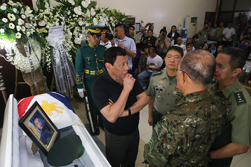 President Rodrigo Duterte discuss matters with Defense Secretary Delfin Lorenzana, Armed Forces of the Philippines chief of staff Gen. Eduardo Año and Lieutenant General Glorioso Miranda while visiting the wake of Captain Clinton Capio inside the mortuary of the Libingan ng mga Bayani in Fort Bonifacio on January 16, 2017. Capio, a Philippine Military Academy Class 2006, was killed in a clash with the Abu Sayaff members last Thursday. KING RODRIGUEZ/Presidential Photos