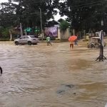 Local folks wade through the floodwaters in the town proper of Kapalong, Davao del Norte on Tuesday morning. Continuous rains in the region have inundate various parts of the province. Photo courtesy of Phoebie Graza