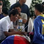 President Rodrigo Duterte condoles with the family of slain Cpl. Michale Yadao at Eastern Mindanao Command headquarters in Davao City on Friday. Yamado and Pvt. Virnin Damondon were killed in an encounter with New People’s Army (NPA) rebels in Barangay Lacson in Davao City last February 16. Newsline Photo
