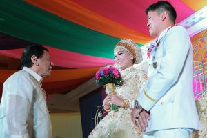 President Rodrigo Roa Duterte extends his well-wishes to the newly-wed couple Senior Inspector Alvin Hosmillo and Senior Inspector Alnieza Kinang-Hosmillo during the reception at the Astoria Regency Convention Center in Zamboanga City on February 12, 2017. The President is one of the principal sponsors for the Kinang-Hosmillo nuptials. The couple caught the public's eye after Hosmillo made a public proposal to Kinang who was among the aide-de-camp of the President during an event at the Police Regional Office 13 sometime in October last year. ALBERT ALCAIN/Presidential Photo