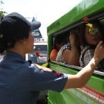 Members of the Davao City Police Office distribute flowers to commuters along San Pedro Street on Valentines Day, February 14. Newsline Photo