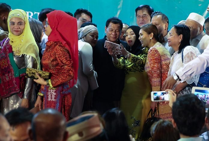 President Rodrigo Roa Duterte grants a photo opportunity with guests during the launch of the Bangsamoro Transition Commission at the Waterfront Insular Hotel in Davao City on February 24, 2017. TOTO LOZANO/Presidential Photo