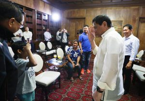 President Rodrigo Roa Duterte, during a meeting at the Malacañan Palace on February 28, 2017, salutes to Rexon Romoc, an eight year-old boy who was released from his Abu Sayyaf abductors on February 27, 2017 after seven months in captivity. KING RODRIGUEZ/Presidential Photo