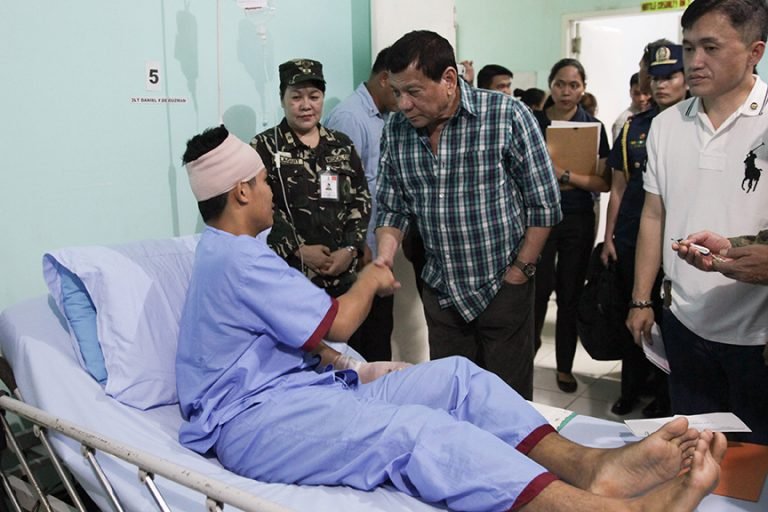 President Rodrigo Roa Duterte shakes the hands of 2Lt. Daniel De Guzman, one of the soldiers wounded-in-action in an encounter with the New Peoples Army recently. The President awarded the Wounded Personnel medal to the soldiers during his visit at Camp Evangelista Station Hospital in Cagayan de Oro City on March 3, 2017.ALBERT ALCAIN/Presidential Photo