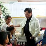 President Rodrigo Roa Duterte comforts one of the children of the late PO1 Rholly Benelayo during his wake visit at the Bansalan Municipal Lobby in Davao del Sur on March 9, 2017. Benelayo is one of the four police officers who were killed in an ambush by suspected members of the New People's Army in the municipality of Bansalan, Davao del Sur on March 8, 2017. Also in the photo is Philippine National Police Director General Ronald dela Rosa. ROBINSON NIÑAL/Presidential Photo