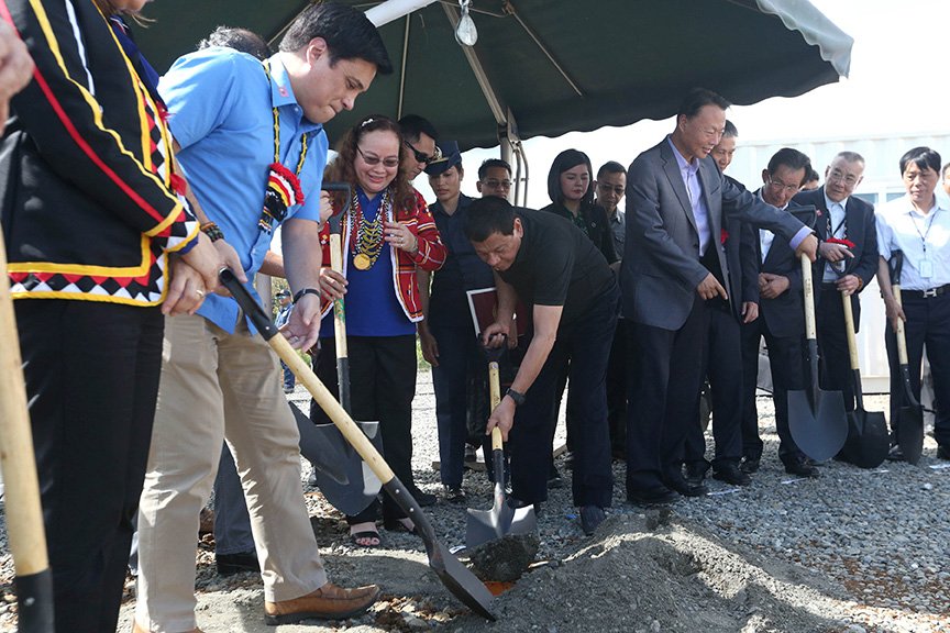 President Rodrigo Roa Duterte is assisted by Senator Juan Miguel Zubiri as he prepares to bury the time capsule during the groundbreaking ceremony of the construction site of the P700 million Drug Abuse Treatment and Rehabilitation Center donated by Friends of the Philippines Foundation (FPF) in Malaybalay City, Bukidnon on March 25, 2017. Also in the photo are Health Secretary Paulyn Ubial (Zubiri's right) and Chinese Ambassador to the Philippines Zhao Jianhua (fifth from right). SIMEON CELI JR./Presidential Photo