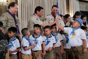 HIGH FIVE. President Rodrigo Roa Duterte interacts with one of the members of the Kabataan Imumulat Diwa (KID) Scout following a photo opportunity during the Baden Powell Day of the World Scout Organization of the Scout Movement and Investiture Ceremony of the Boy Scout of the Philippines (BSP) at the Rizal Hall in Malacañan Palace on April 3, 2017. ROBINSON NIÑAL JR./Presidential Photo