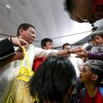President Rodrigo Duterte is assisted by Social Welfare Secretary Judy Taguiwalo  as he shares his pasalubong of chocolates to the children of the 160 repatriated Overseas Filipino Workers (OFWs) who were granted amnesty after they were found working illegally in the Kingdom Saudi Arabia. The President welcomed the repatriated 'runaway' OFWs and provided them with cash assistance upon his arrival at the Ninoy Aquino International Airport Terminal 1 on April 17, 2017 following his successful visits to the Kingdom of Saudi Arabia, Bahrain and Qatar. KING RODRIGUEZ/ Presidential Photo