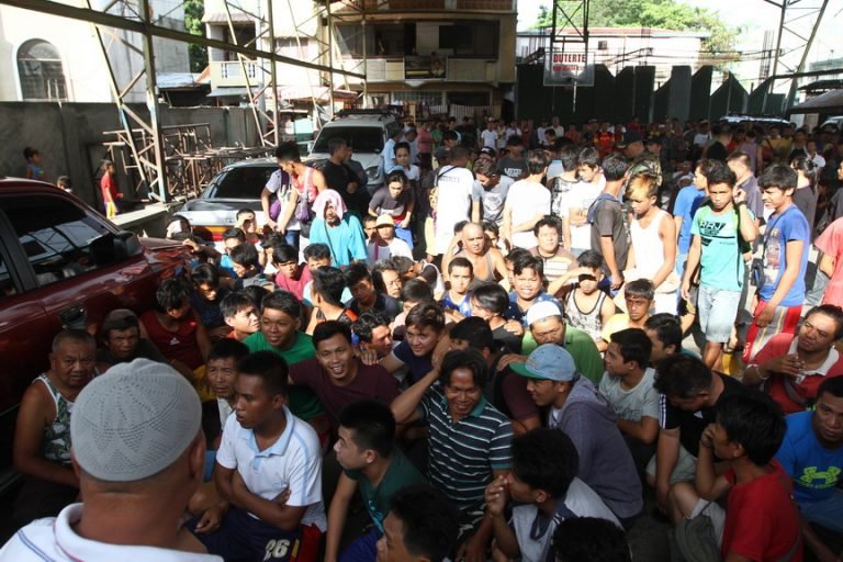 Resident of Barangay Mini Forest in Davao City gather at a covered basketball court for identification verification during the "Operation Bolabog" on Thursday. The operation was meant to verify non-residents as part of the city's tightened security measures. Newsline Photo