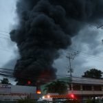 Thick smoke billows above a plant of Sagrex packing plant in Barangay Hizon, Davao City following a fire that started around 4:30 p.m. on Monday, 12 June 2012. At least 15 firefighters, including volunteers, were injured when an LPG tank of the plant exploded around 6:00 p.m. causing panic among bystanders. Newsline Photo