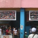 Streamers printed with the pictures of suspected local terrorists posted outside a business establishment along San Pedro Street in Davao City.  Newsline Photo