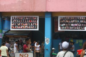 Streamers printed with the pictures of suspected local terrorists posted outside a business establishment along San Pedro Street in Davao City.  Newsline Photo