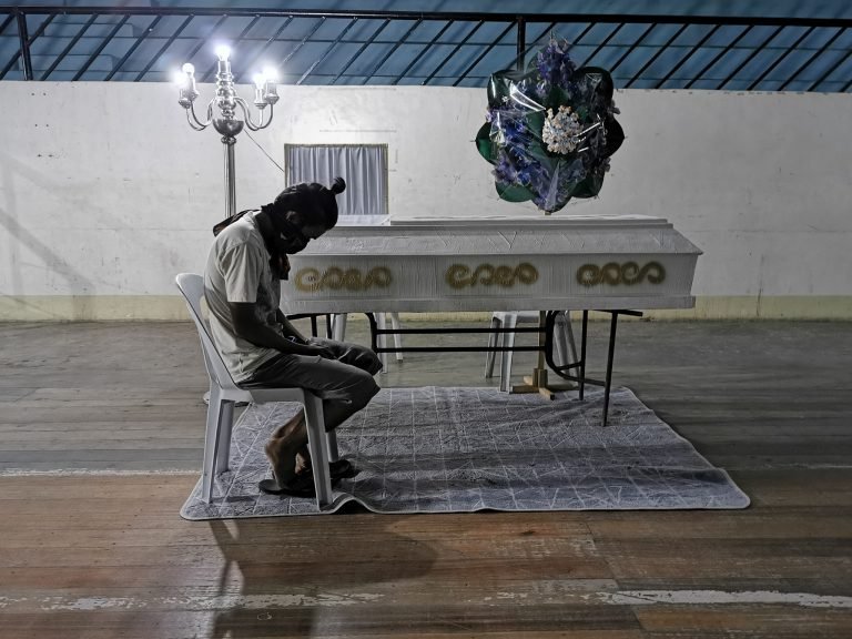 A coffin keeps curfew and liquor ban violators awake