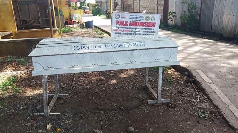 Empty coffin warns residents to stay at home