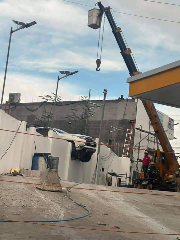 Car leaps through concrete barrier