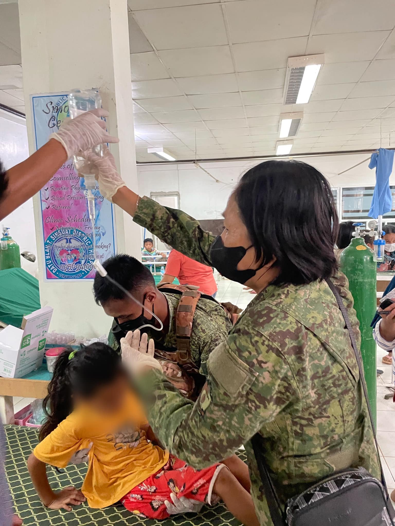 Soldiers help affected schoolchildren at the health clinic