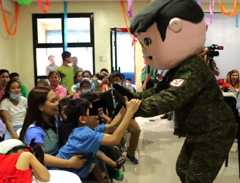 Soldiers put a smile to  children with special needs through gift giving