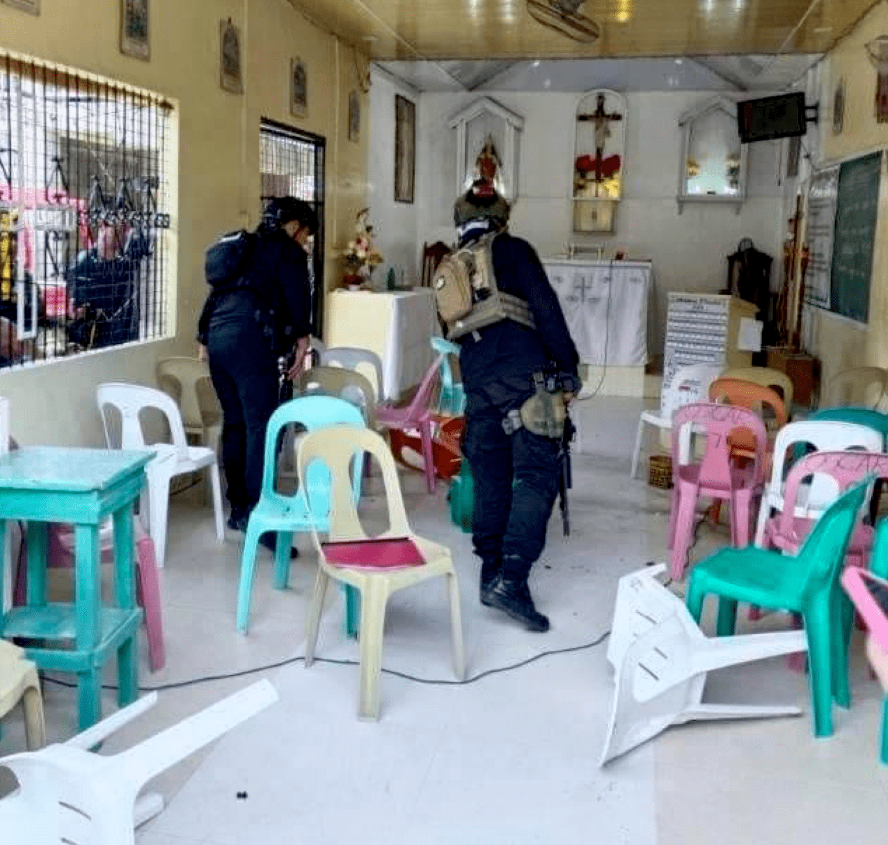 Police investigators searching for the fragments of the grenade which wounded two churchgoers on Sunday May 19 in Cotabato City